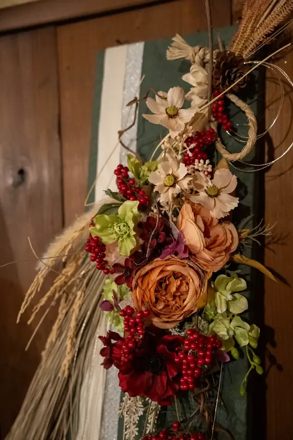 Dried flowers on an old timber pillar